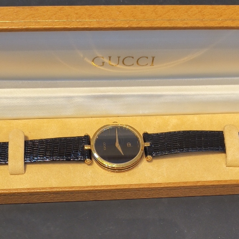 Gucci Black and Gold Timepiece